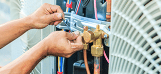 hvac technician repairing hvac system