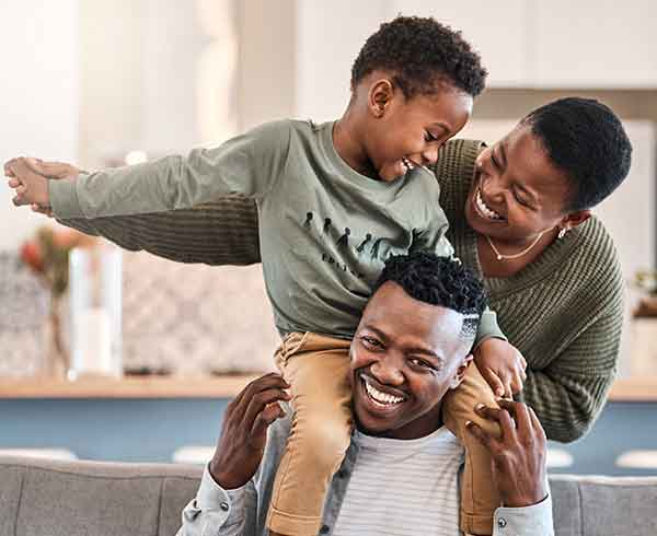 dad, mom and son enjoy playing in the home